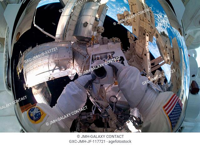 Because of his shiny helmet visor, this self portrait of NASA astronaut Mike Fossum, photographed during a July 12 spacewalk