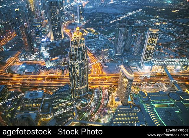 Aerial View Of Street Night Yellow Illumination Of Traffic In Residential District In Dubai. City Night Scenic View Of Skyscraper In Dubai