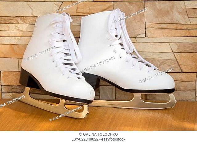 The female skates and boots of white color for figure skating