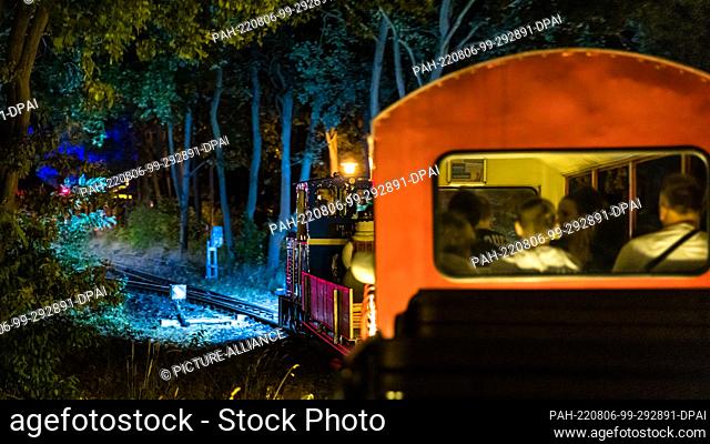 05 August 2022, Brandenburg, Cottbus: Passengers sit in a wagon during the so-called light rides of the Cottbus park railroad
