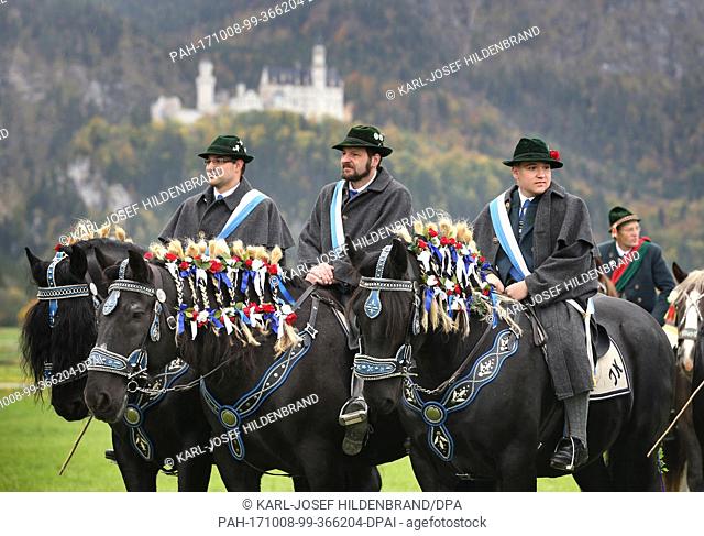 Men and women in traditional dress ride on festively adorned horses from the St. Coloman church near Schwangau, Germany, 8 October 2017