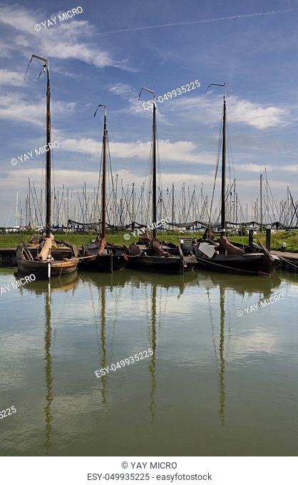 Historic sailing boats in a harbour near the Zuiderzee museum in the Dutch city Enkhuizen