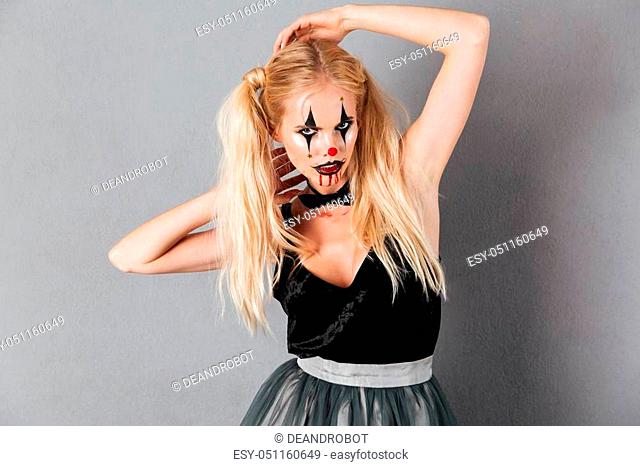 Image of young blonde woman in halloween make up posing and looking at the camera