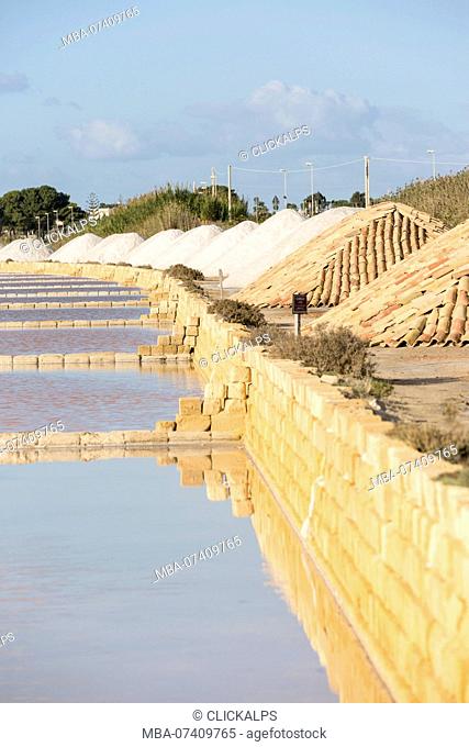pyramids of salt drying along the salt pans of Marsala, Trapani province, Sicily, Italy