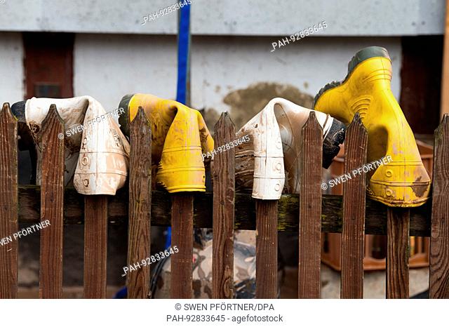 dpatop - Boots hung up to dry on a picket fence in Rhuedel, Germany, 27 July 2017. Persistent rain across southern Lower Saxony and parts of Saxony-Anhalt...