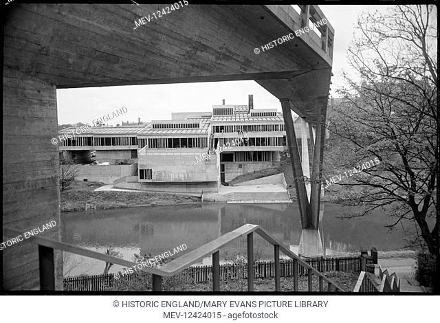 An exterior view of the river front of Dunelm House, Durham University's student union, seen from the west bank of the River Wear and showing the underside of...