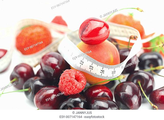 measure tape, strawberry, apricot, cherry and raspberry isolated on white