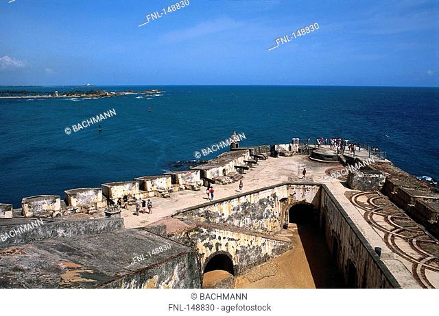 Tourists on the roof of an old castle at the coast, El Morro, Old San Juan, Puerto Rico