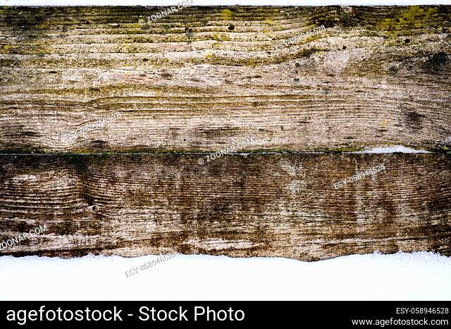 Old vintage wood wall with snow. Winter and christmas background. Wood planks, boards are old with a beautiful rustic look