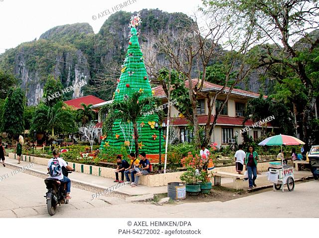 A big Christmas tree made from plastic bottles is erected in El Nido on the isle of Palawan in the Philippines, 11 December 2014