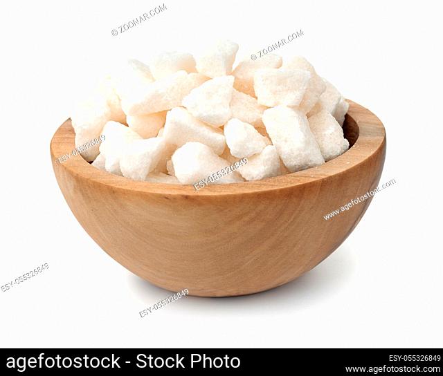 Organic crushed lump sugar in wooden bowl isolaed on white