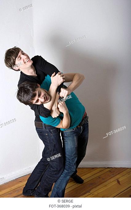 Young gay couple play fighting