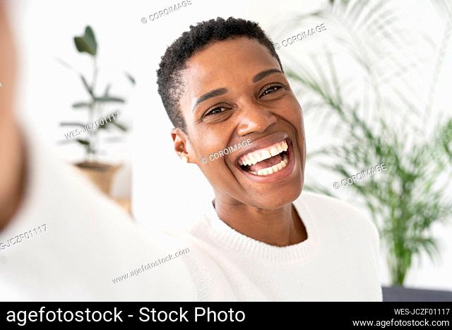 Portrait of laughing woman at home