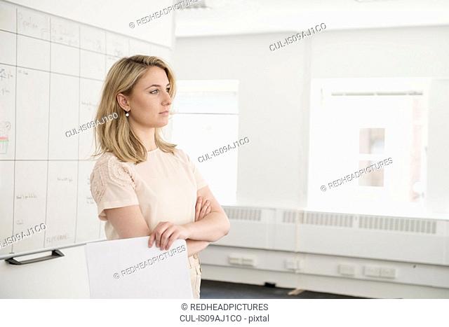 Young businesswoman contemplating in office