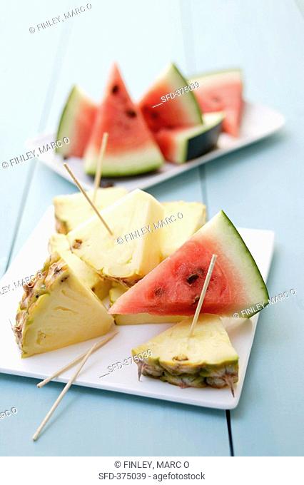 Pieces of pineapple & watermelon with wooden cocktail sticks