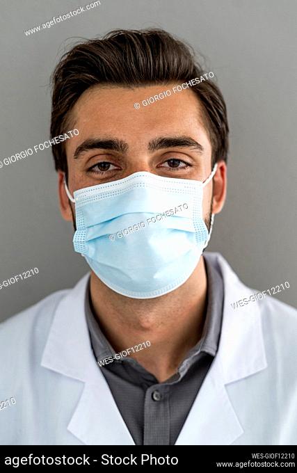Male healthcare worker wearing protective face mask during COVID-19