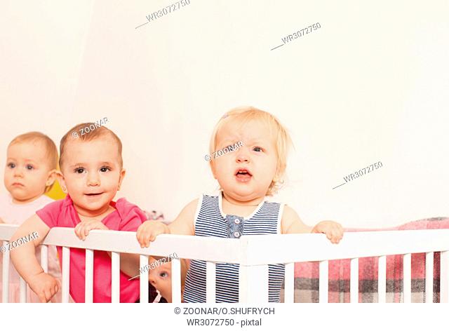 Three baby girls in the crib