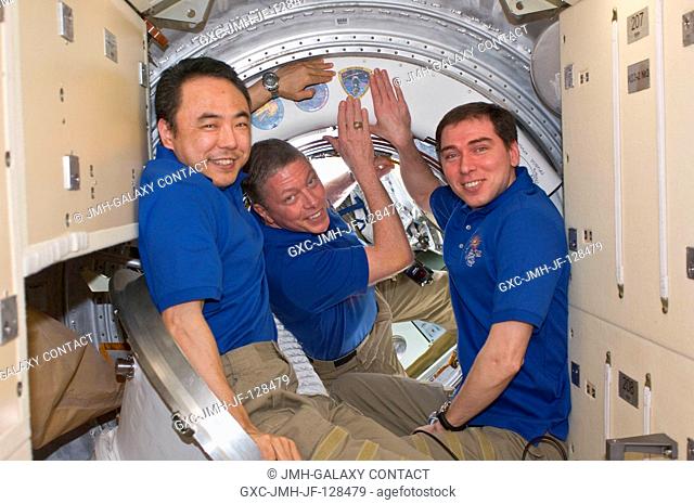In the Rassvet Mini-Research Module 1 (MRM1), Expedition 29 crew members add the Soyuz TMA-02M patch to the growing collection of insignias representing crews...