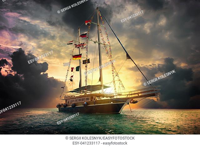 Sailboat in the sea and storm clouds