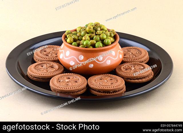 Indian snack: Cream Biscuit and Spiced fried green peas {chatpata matar} in plate