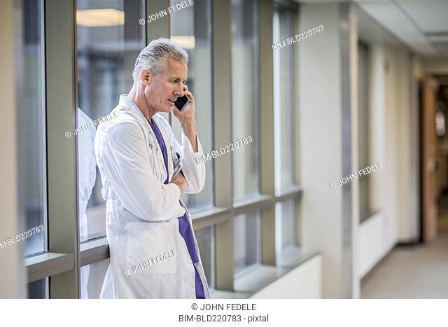 Caucasian doctor talking on cell phone