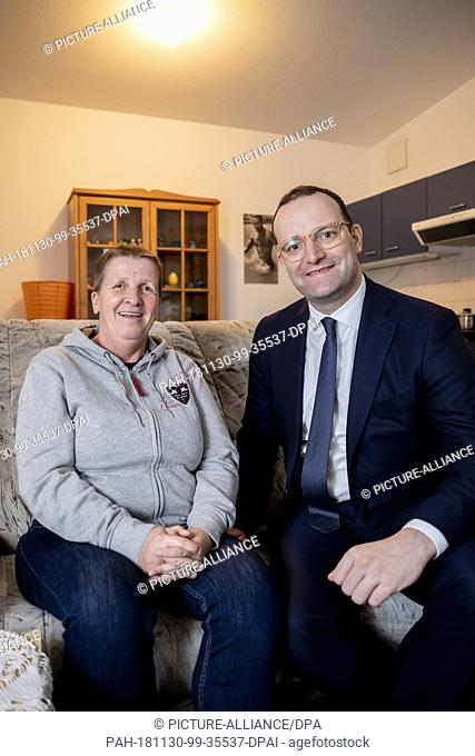 30 November 2018, Berlin: Jens Spahn (CDU), Federal Minister of Health, sits with Angelika Dzemailova (l) in her apartment during a visit to the housing project...