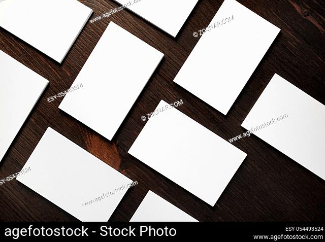 Blank business cards on wood table background. Mockup for branding ID. Flat lay