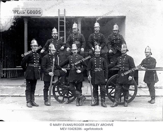Ten members of the Carmarthen fire crew pose for their photograph outside Coopers' Goods in Carmarthen, the county town of Carmarthenshire, Dyfed, South Wales
