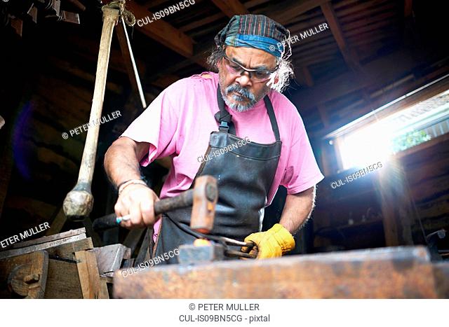 Blacksmith working in his forge