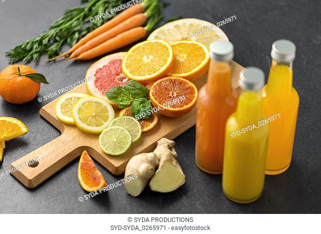 glass bottles of fruit juice on slate table top