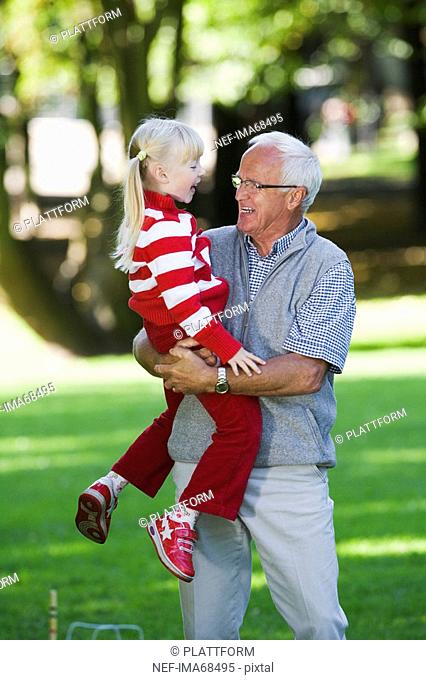 A girl with her grandfather in the park Sweden