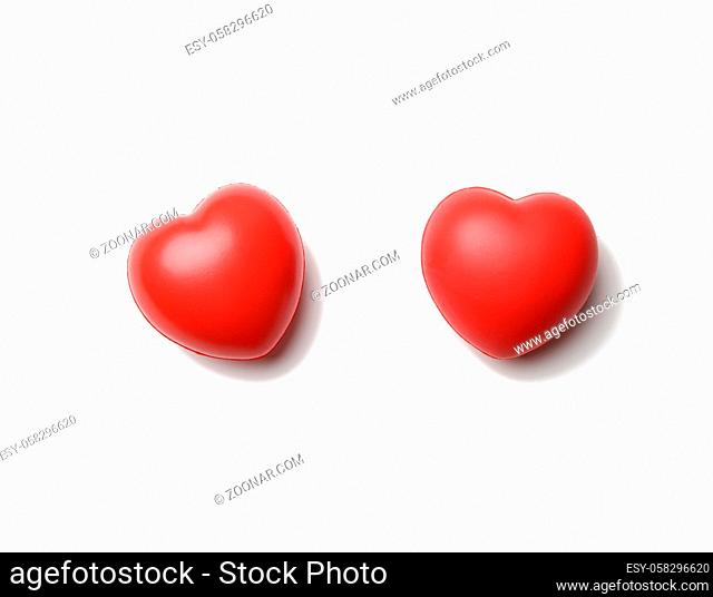 red rubber heart isolated on white background, close up