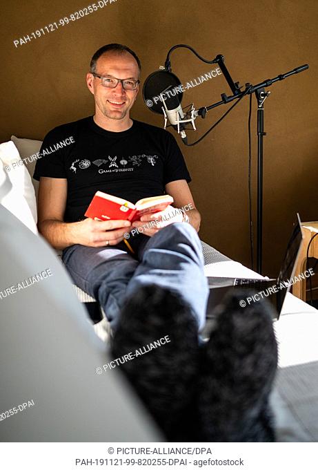 29 October 2019, Lower Saxony, Kakenstorf: Toby Baier, ""falling asleep"" podcaster, sits in his study and is in the process of making a new contribution