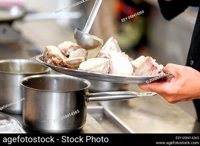 Close up, photo of chef hands adding a sauce to a tray with food. High quality photo