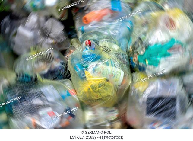Close Up of garbage and waste in transparent bags. Radial blur effect