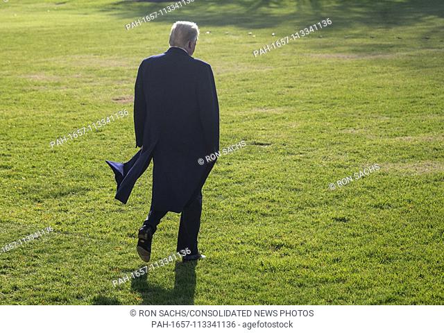 United States President Donald J. Trump walks across the South Lawn of the White House after making remarks to the press at the White House in Washington