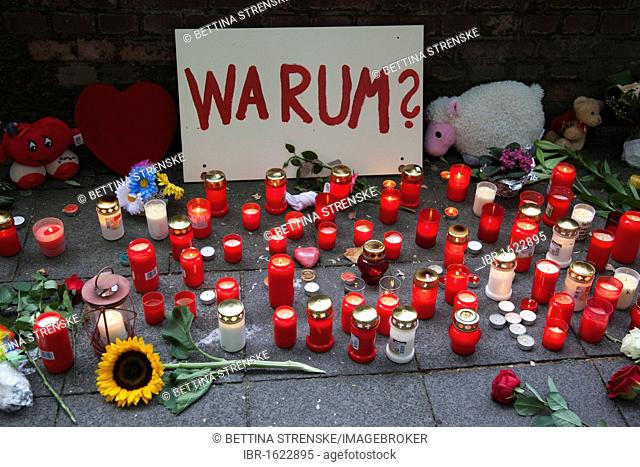 Sign saying warum?, why?, and candles to commemorate the victims of the stampede at the Love Parade 2010, Duisburg, Ruhr Area, North Rhine-Westphalia, Germany