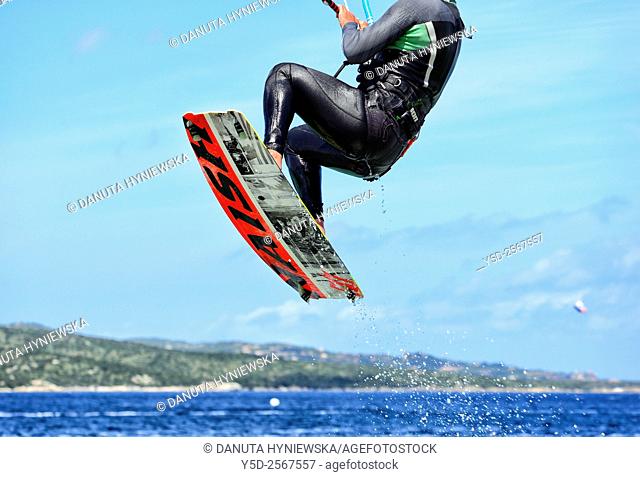 Jumping male kitesurfer - Porto Pollo near Palau, Province Olbia-Tempio, northen Sardinia, Italy