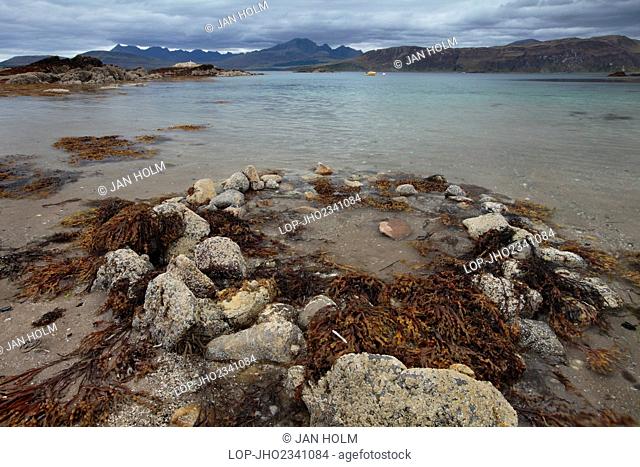 Scotland, Highland, Ord. View from the shore towards a small boat moored on Loch Eishort on the Isle of Skye