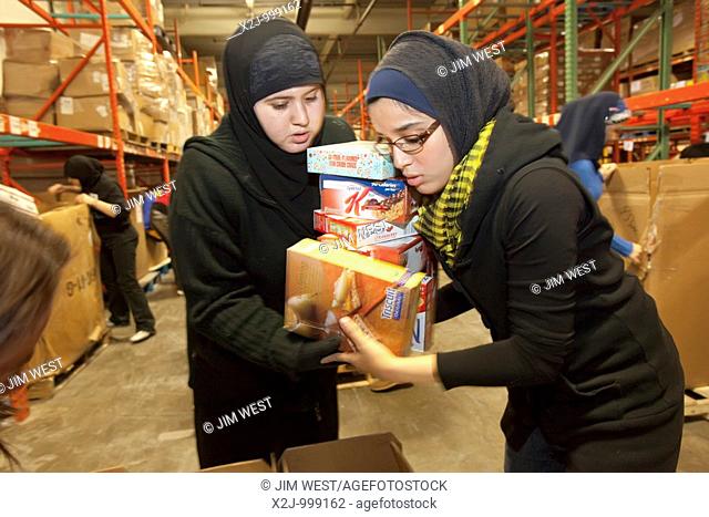 Detroit, Michigan - Arab-American teenage volunteers pack food for the hungry at the Gleaners Community Food Bank  It was part of a Martin Luther King Day of...