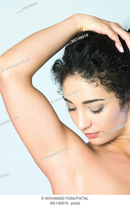 Close up of a young woman looking at shaved armpits