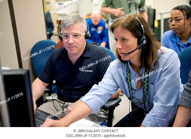 NASA astronauts Gregory H. Johnson, STS-134 pilot; and Shannon Walker, Expedition 2425 flight engineer, use the virtual reality lab in the Space Vehicle Mock-up...