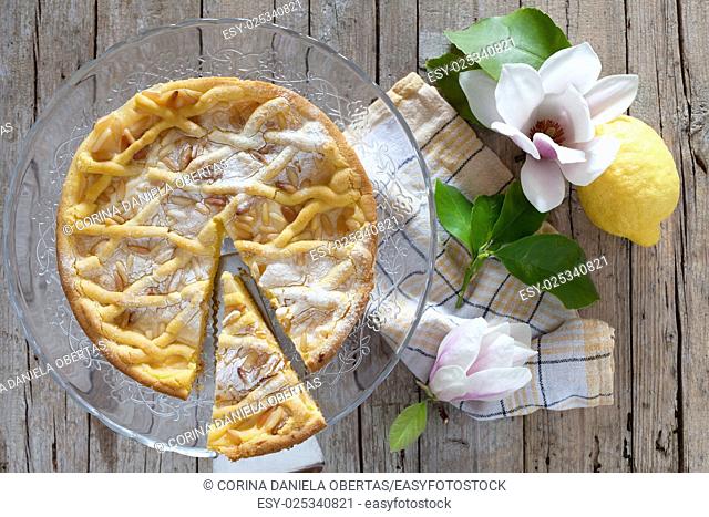 Slice of grandmas cake, typical cake from Tuscany, Italy, made with shortbread pastry, ricotta cheese and pine nuts