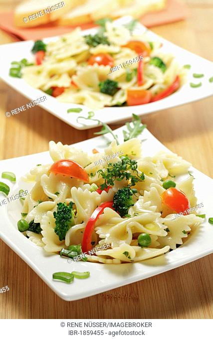 Farfalle pasta salad with capsicum, broccoli, tomatoes, peas and green onions