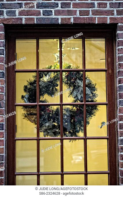 Christmas Wreath, Backlit in a showcase, mulit-paned window, New York City