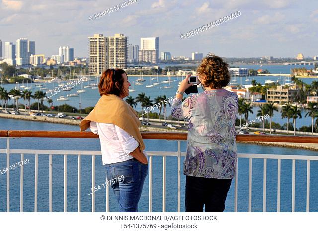 Passengers on cruise ship viewing Miami Florida skyline and harbor