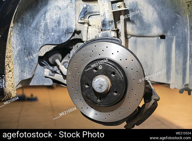 Detail of the Replacement of a car disc brake in the mechanical workshop