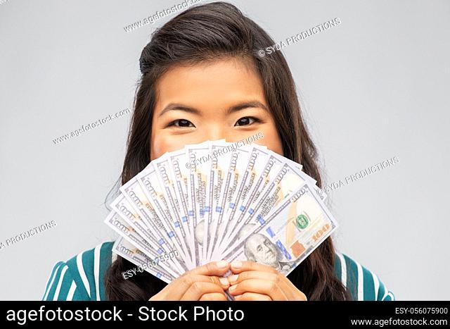 asian woman with hundred dollar money banknotes