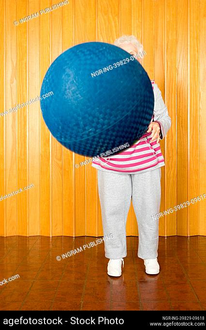 Senior woman exercising with a ball