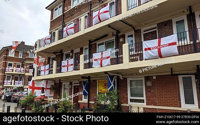 17 June 2021, United Kingdom, London: In Bermondsey, east London, the residents of the Kirby Estate hang out flags. Since the start of the European Football...